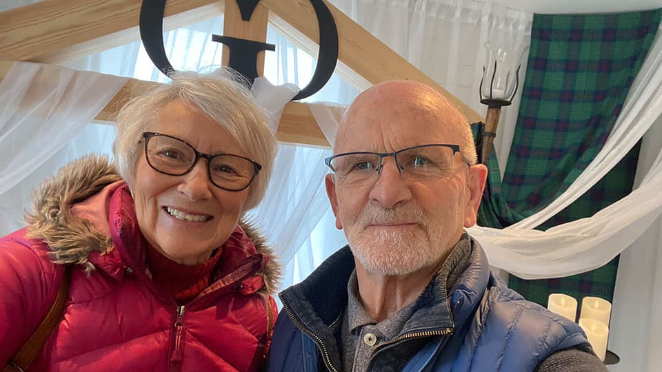 Bryan with his wife at a Loughborough University event. They are standing together and smiling.
